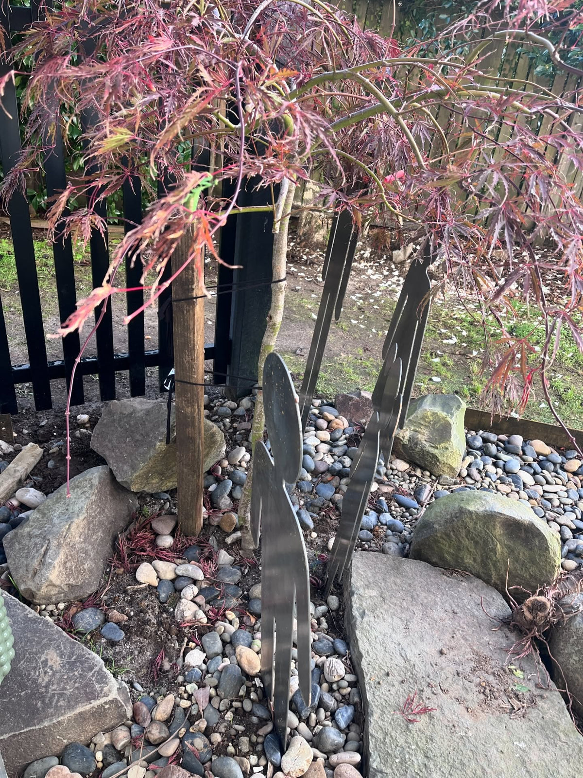 Side view of steel family silhouette garden sculptures